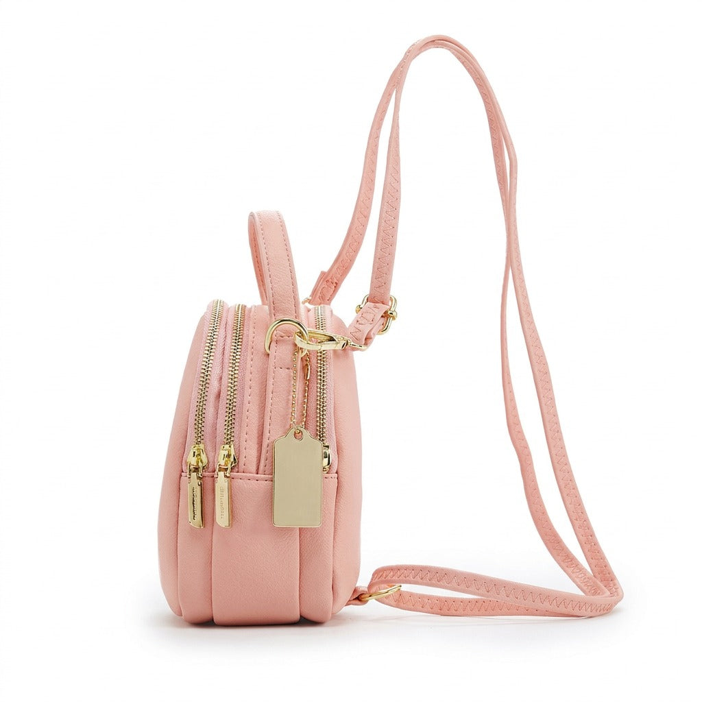 Profil du mini sac à dos Philippine rose montrant les trois compartiments zippés et la sangle