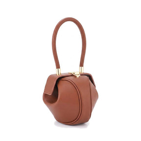 Sac boule en cuir cognac Faustine à anse ronde, vue de face sur fond blanc