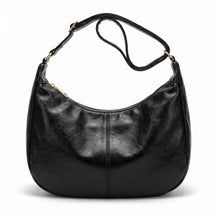 Sac hobo en cuir noir Colombe avec large sangle à boucle dorée, vue de face sur fond blanc