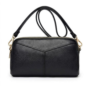 Sac bandoulière en cuir noir Mathilde à double zip doré, vue de face sur fond blanc