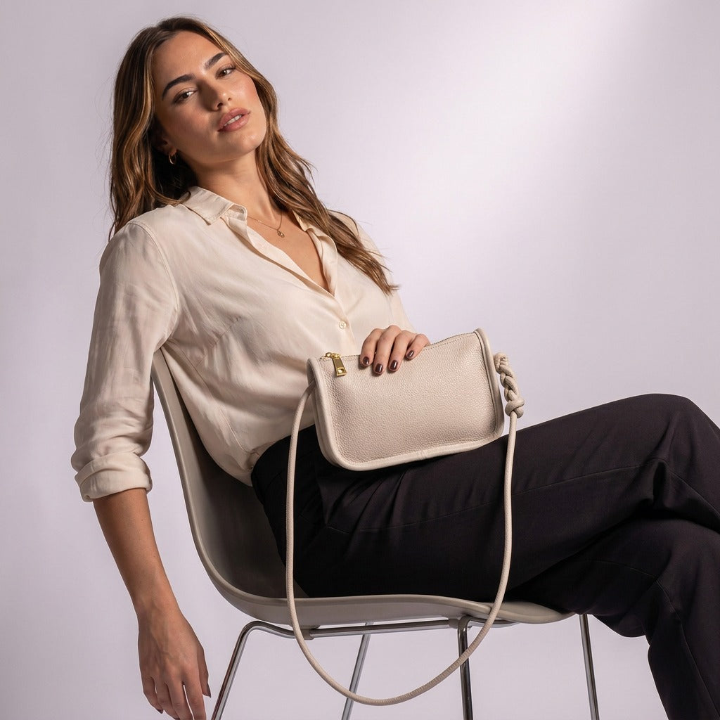 Femme assise avec le sac Capucine beige sur les genoux