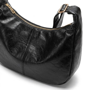 Détail de la fermeture éclair dorée et de la couture centrale du sac Colombe noir