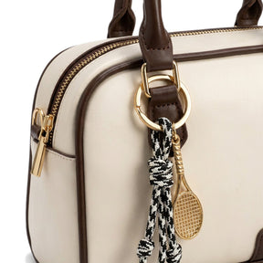 Détail du bijou de sac raquette dorée et cordons tressés du mini sac bowling Iris